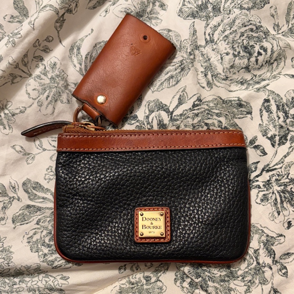 Dooney & Bourke Black Pebbled Leather Wristlet with Brown Trim and Gold Plaque
